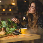 woman holding fork in front table photo